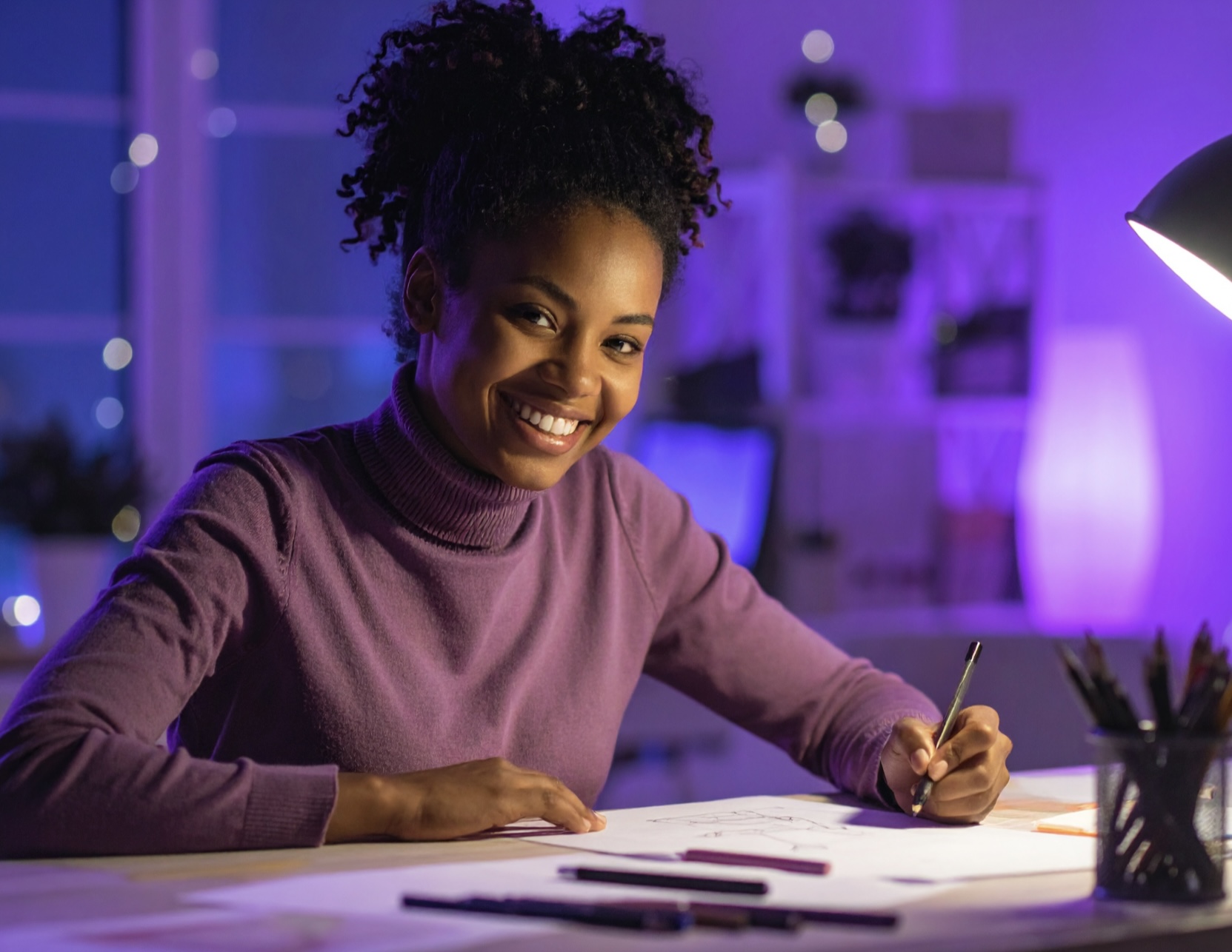 graphiste/illustratrice qui travaille sur un projet de livre avec le sourire